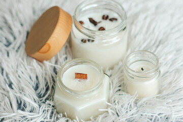 Scented candles in the interior. Interior details in milk colors. Candles in a glass