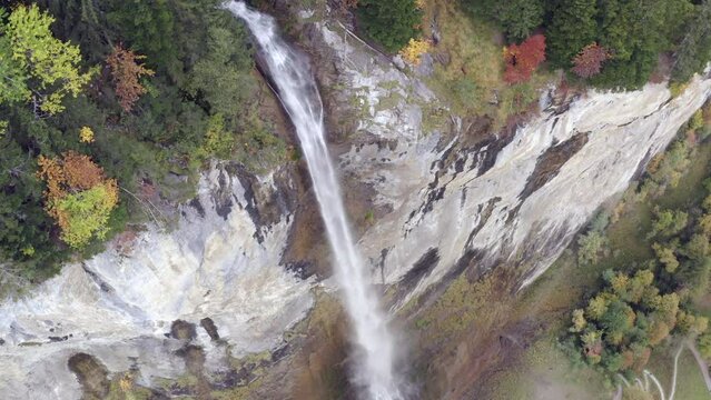 Aerial view of a waterfall surrounded by autumn colors in Lauterbrunnen, Switzerland