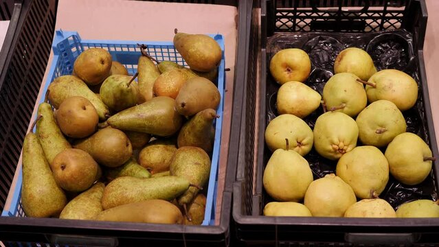 Close-up of ripe pears in boxes in the supermarket.