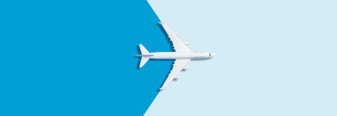 Flat lay design of travel concept with plane on blue background with copy space - obrazy, fototapety, plakaty