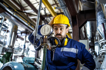 Portrait of factory worker in panic having problem with production trying to find solution for the...