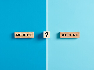 The words reject and accept on wooden blocks with question mark symbol.