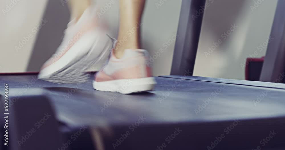 Poster Closeup of feet walking, jogging and running on a treadmill with a healthy, fit and active female athlete. Sporty woman exercising, training and working out for cardio, endurance and lifestyle