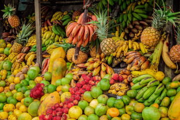 A traditional fresh fruit stall, concept of assorted fruits and healthy food. View of a traditional fruit stall, Shelf with variety of fresh fruits for sale
