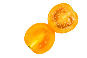 Yellow tomato cut in half on a white background.