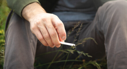 Man smoking cigarette in outdoor. Concept of smoking