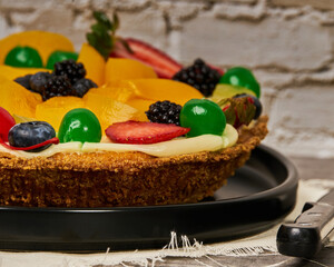 fruit cake with strawberries, blueberries, cherries and peaches side view