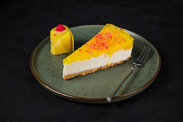 A piece of mango cheesecake with mascarpone cream cheese filling, garnished with fresh mango,...