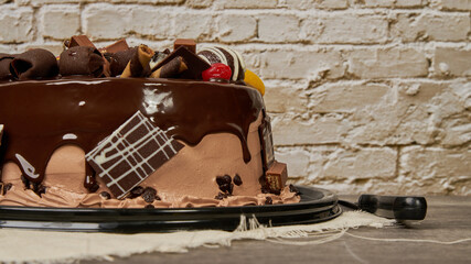 chocolate cake with cherry and peach chocolates decoration, side view