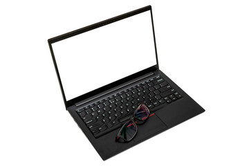 Eyeglasses on black laptop keyboard