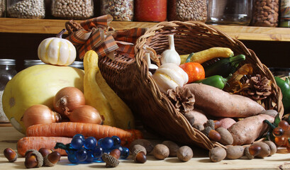 Baskets of Fresh Vegetables and Bread in Rustic Kitchen With Jars of Dried Food in Background