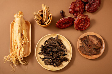 Herbal ingredients used in traditional Chinese medicine, ginseng and reishi mushrooms in brow...