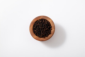 Cup of Black pepper placed on a white background. 