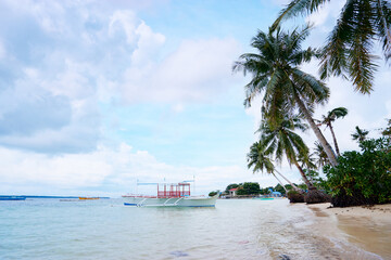 Beach with traditional fishing boats, Philippines.