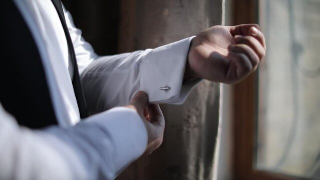 Love story, Groom adjusts the sleeve of his shirt