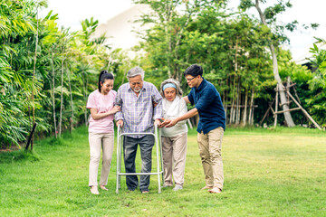Naklejka na ściany i meble Portrait enjoy happy smiling love multi-generation asian big hug family.Senior mature father and elderly mother with young adult woman and son outdoor in park at home.insurance concept
