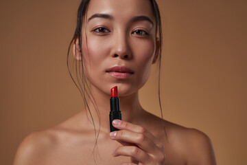 Partial of serious asian girl with lipstick