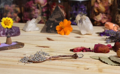 Obraz na płótnie Canvas Dried Lavender and Rose Petals on Table With Incense Cones and Crystals