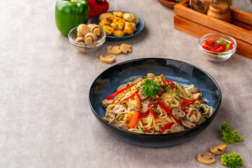 Spaghetti aglio e olio is a traditional Italian pasta dish from Naples. Recipe for classic aglio e olio pasta with fried garlic, mushroom, paprika, parsley and hot pepper.