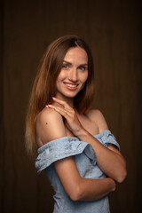 studio portrait on a dark background of a beautiful young woman