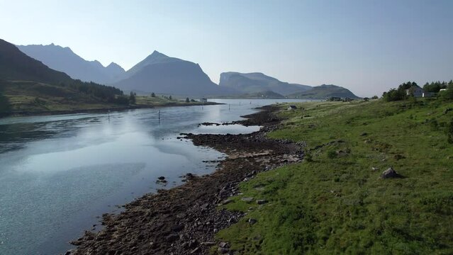 Low aerial drone shot of Norwegian shoreline during summer in Lofoten