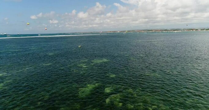 Aerial shot of fisherman preparing his net walikng in shallow water