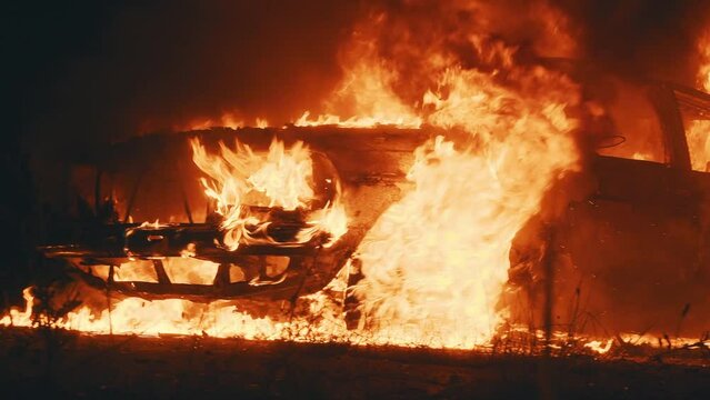 Abandoned burning car because of fuel ignition after shelling