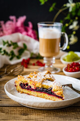 Fototapeta na wymiar Fruit cake with white coffee on wooden table 