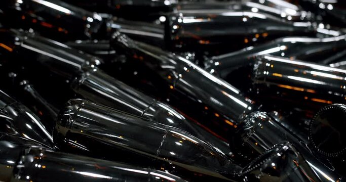 Close-up of brown bottles in a factory. A long row of glass bottles. Top view of a production line. Factory concept. Factory brewery concept.