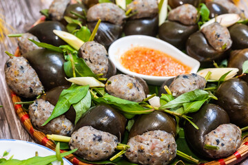 Steamed snails with lemongrass ( Oc doi hap xa).  The ingredients include ground pork, pork leg, tamarind, vermicelli, spices, puree and then leave the shell.