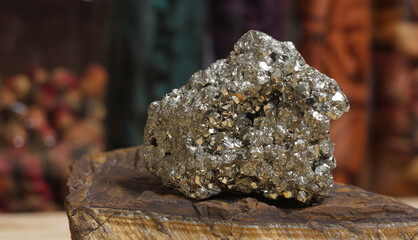 Pyrite Specimen on Raw Tigers Eye Rock With Dried Herbs in Background