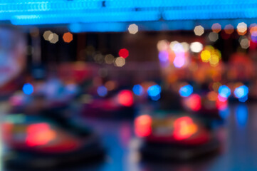 Fototapeta na wymiar Abstract random colourful defocused blurred go-kart cars of fun fair background pattern