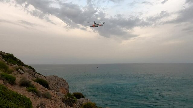 OROPESA DEL MAR, SPAIN - JUNE 2022: Marine rescue helicopter doing a search and rescue drill