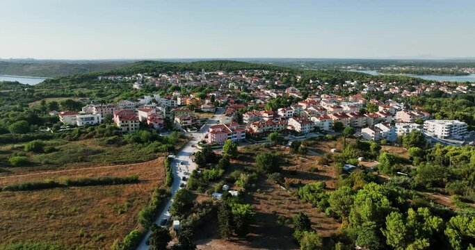Aerial view around the town of Premantura in sunny Croatia- circling, drone shot