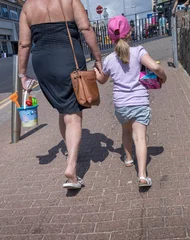 Fototapeten Girl with mother. Walking to the beach. Clacton on sea. Essex. England. UK, Great Brittain. Seaside resort. © A