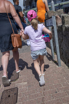 Girl With Mother. Walking To The Beach. Clacton On Sea. Essex. England. UK, Great Brittain. Seaside Resort.