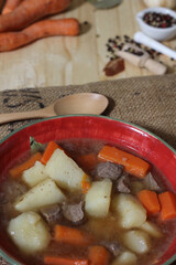 Hearty Beef Stew With Potato and and Carrots on Vintage Burlap potato Bag