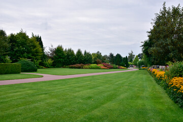 Fototapeta premium A show garden with grasses, a lake and various decorations in Poland.