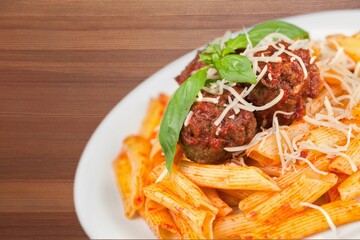 Tasty fresh dish in the plate on the wooden table.
