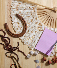 Horseshoe With Vintage Lace Fan Beads and Arrowheads on Wooden Background