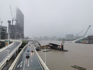 Brisbane, Australia - February 27, 2022: Wild weather and heavy rain falls from Tropical Cyclone storm Brisbane Central Business District. There are many cars drive on M3 highway.