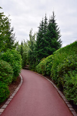 A show garden with grasses, a lake and various decorations in Poland.