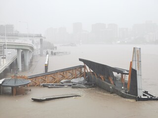 Brisbane, Australia - February 27, 2022: Wild weather and heavy rain falls from Tropical Cyclone storm Brisbane Central Business District. The North Quay ferry terminal is flooded and closed. - obrazy, fototapety, plakaty