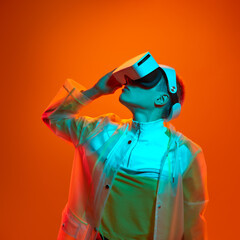 Serious lady watching video in contemporary VR headset