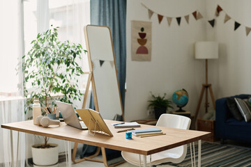 Horizontal image of desk of pupil with laptop and notebooks for online studying in the room