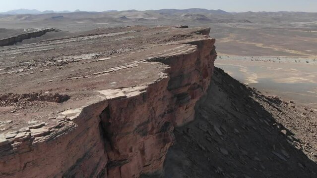 Cliff at Gara Medouar rock formation in Errachidia region, Morocco. Aerial drone pov