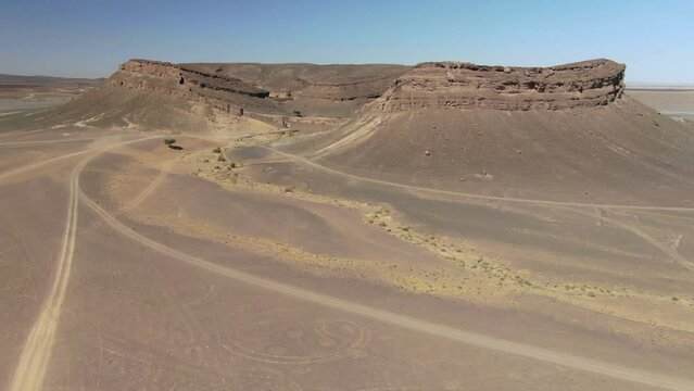 Beautiful unusual Gara Medouar horseshoe shaped rock formation in Morocco. Aerial drone approach
