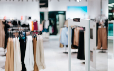 Out of focus entrance to boutique clothing store in supermarket. Selective focus on frame electronic article surveillance