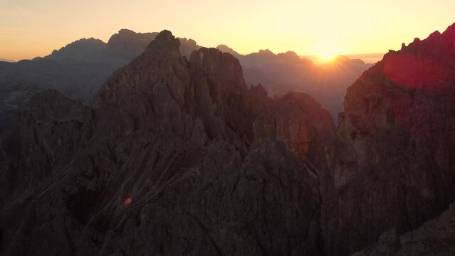 A colorful 4K drone shot of an amazing sunrise in the mountains and rock formations of the Dolomites in South Tyrol in Italy. Very close to Rifugio Fratelli Fonda Savio