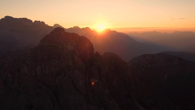 Amazing and colorful 4K drone shot of a sunrise in the mountains and rock formations of the Dolomites in Italy. Locations very close to Rifugio Fratelli Fonda Savio and the Tre Cime di Lavaredo